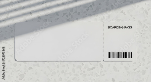 Blank boarding pass on a textured surface with shadow overlay