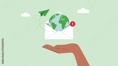 Hand holding envelope with globe and paper airplane earth