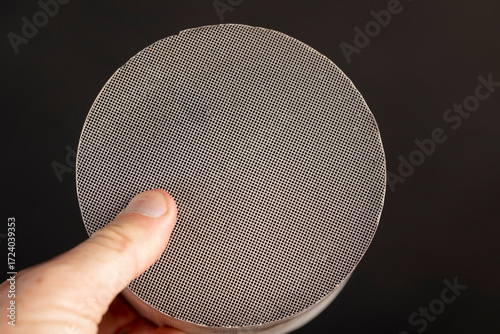 parts of an old ceramic catalyst made of modern materials, which has been used for a long time and has various damages, an automotive part is a ceramic catalyst with a large number of holes