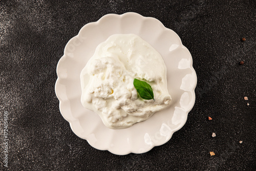 Stracciatella cheese soft young portion size Italian food natural product tasty snack fresh delicious gourmet food background on the table rustic top view copy space