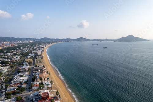 Aerial view of Las Brisas beach and the commercial port of Manzanillo Colima. Coastal landscape with port infrastructure ships and tourist area. Mexico March 02 2026