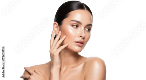 Obraz A woman with glowing, radiant skin and dark hair, posing with her hand on her face, isolated on white isolated on transparent background