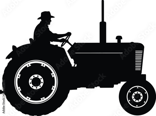 Silhouette of farmer driving vintage tractor in field silhouette