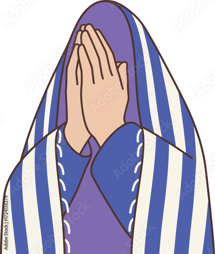 A woman with a peaceful expression covers her face with her hands, praying or meditating while wearing a beautiful striped blue and white shawl over her head.
