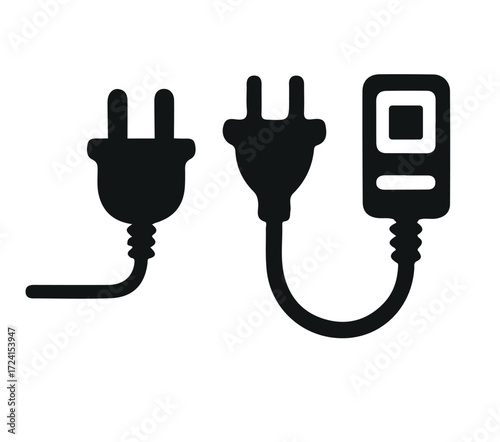Two electrical plugs and a power adapter
