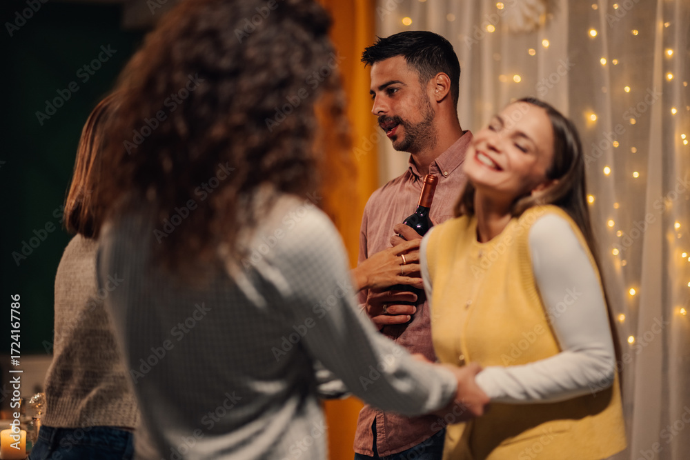 Fototapeta premium Friends enjoying party, dancing and drinking wine