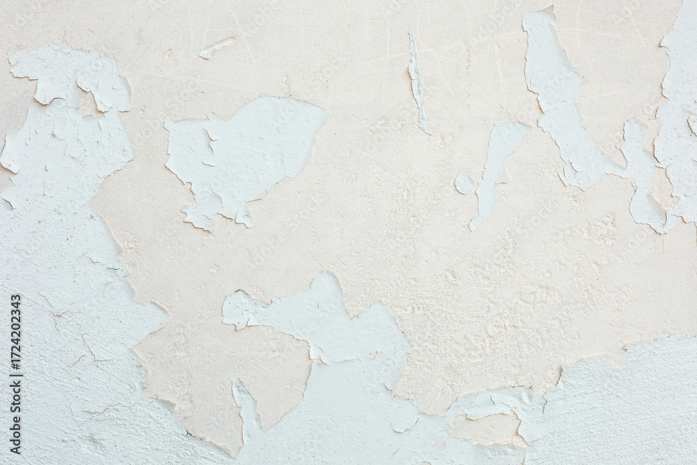 Obraz premium Peeling paint reveals layers of texture on a weathered wall in soft tones