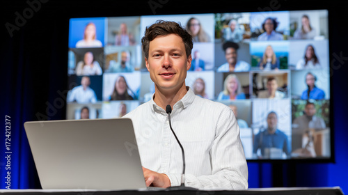 Virtual keynote speaker presenting at online conference with audience on screen and stage lighting on neutral background