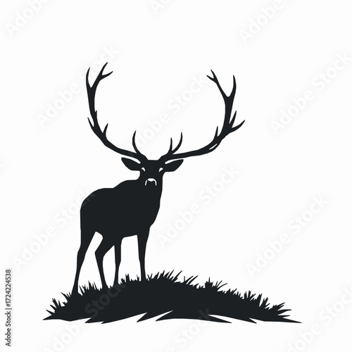Black silhouette of a majestic stag with large antlers standing on a grassy mound Keywords: stag, deer, animal, silhouette, black, antlers, majestic, proud, standing, grass