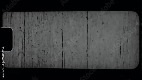 Old damaged film texture loop with vintage scratches and monochrome grain. An authentic retro animated background element for cinematic projects.