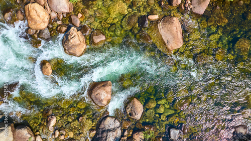 Fotografie Aerial Merced River Flowing Over Rocks and Mossy Riverbed Top Down
