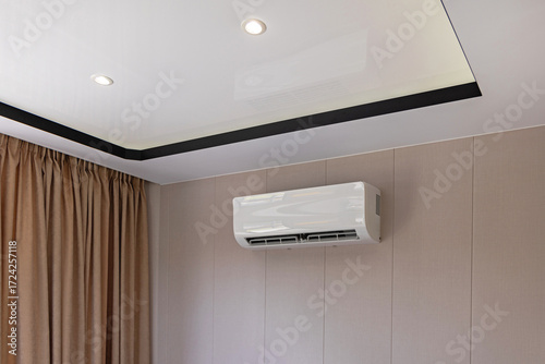 Split System Air Conditioner Mounted at Wall in Living Room Home