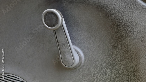 Tableau sur toile Close up of worn grey window crank handle with subtle scratches and dusty finish