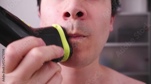 Video of a man shaving his face to remove any beard stubble, a topic of hygiene and personal image