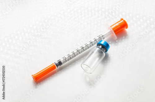 Close up of Empty Vial with Injectable Compounds Next to Syringe