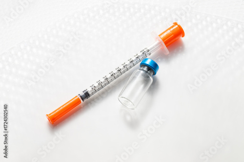 Close up of Empty Vial with Injectable Compounds Next to Syringe