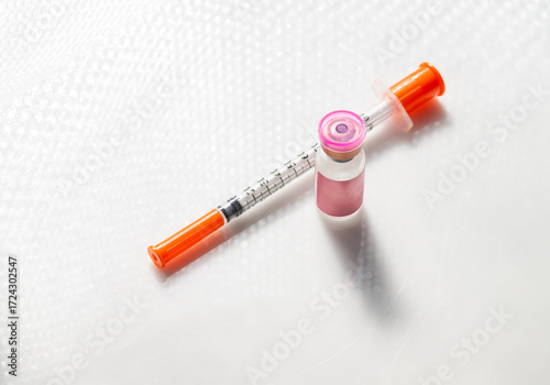 Close up of Vial with Injectable Compounds Next to Syringe