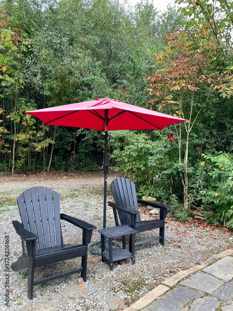 Obraz premium deck chairs and umbrella in garden