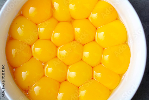 Many egg yolks in the white bowl.