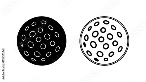 Two golf balls one black and white with dimples.