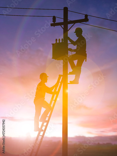 Two Electrician Installing Transformer on Utility Pole at Sunset