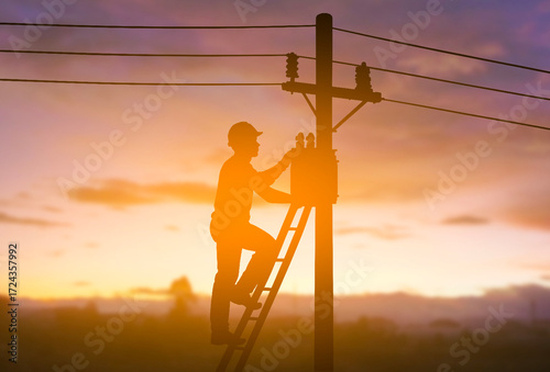 Electrician Installing Transformer on Utility Pole at Sunset
