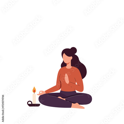 Woman meditating near a lit candle