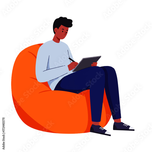 A young man with dark skin sits comfortably in an orange beanbag chair, using a stylus to draw or write on a digital tablet.