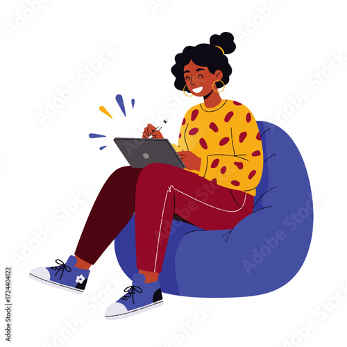 A smiling young woman with dark hair sits in a blue beanbag chair, drawing on a tablet with a stylus.