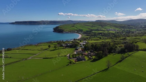 Drone view of the Farms and homes on the Beautiful Rolling hills of the coast of Ireland on the Irish Sea