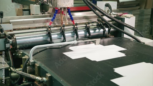 Glue-spreading machine in action at cardboard box manufacturing plant showcasing innovative production techniques and precision engineering