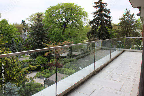 Exterior installation of laminated glass balustrade without frames featuring texture and design patterns