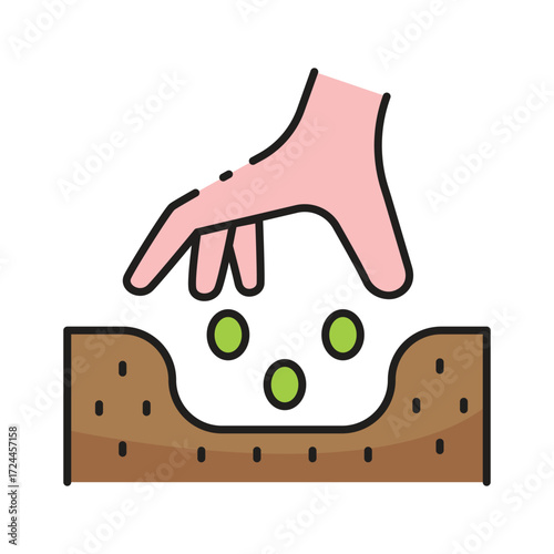 Hand dropping seeds into soil