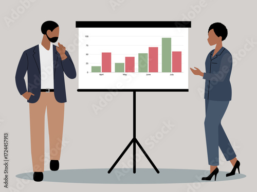 Two business people, man and woman, standing next to a flip chart displaying a bar graph with business trends