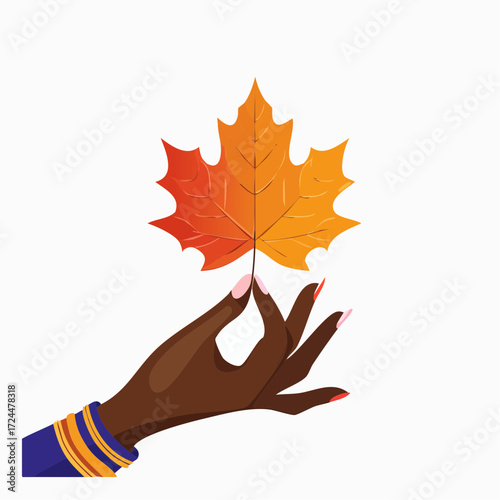 Hand holding a vibrant autumnal maple leaf, symbolizing the beauty of the fall season and the changing colors of nature