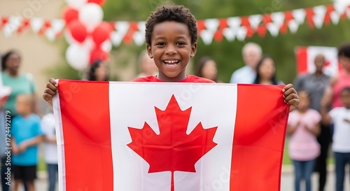 A joyful young person proudly displays the Canadian flag at a celebratory outdoor event.