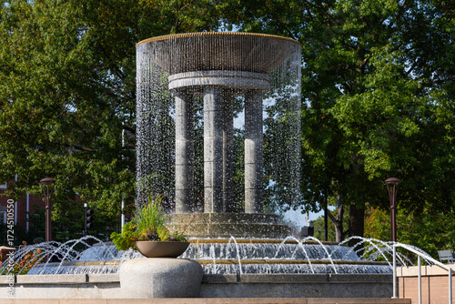 Cascading water fountain in downtown Cary park. Stunning fountain in downtown Cary, North Carolina, with cascading streams of water forming curtain around stone columns.