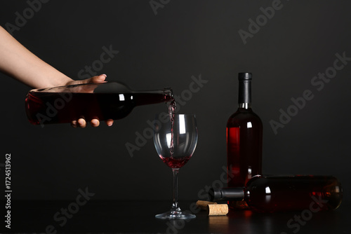Young woman pouring red win...