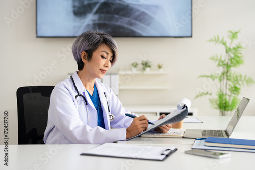 professional female doctor wearing uniform taking notes in journal, physician therapist practitioner filling medical documents, clipboard, patient form, illness history, prescription.