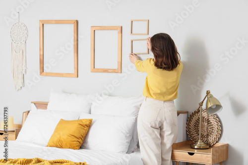 Young woman hanging wooden ...