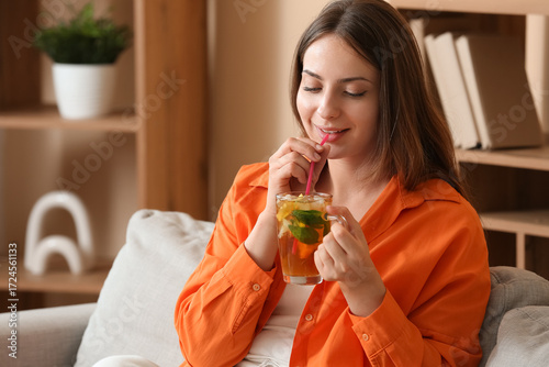 Young woman drinking ice te...