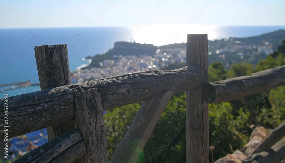 Obraz premium Coastal town view through wooden fence