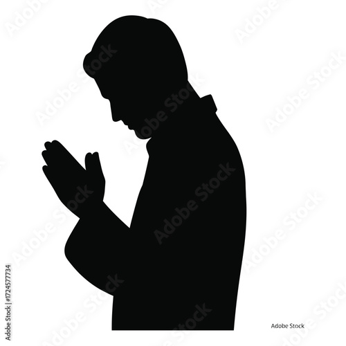 Silhouette of a man praying with hands clasped in devotion