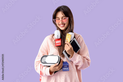 Young woman with gadgets an...