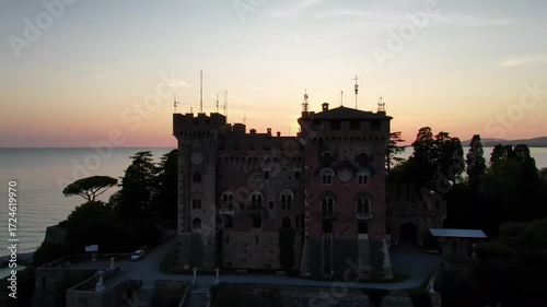 Majestic castle at sunset over tranquil water