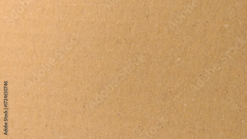 Background of brown kraft paper or cardboard texture. Abstract pattern of beige rough carton, old paper sheet.