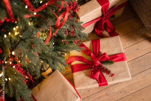 gifts with red ribbon under the Christmas tree