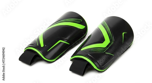 Pair of black  green shin guards with black elastic straps isolated on a white background