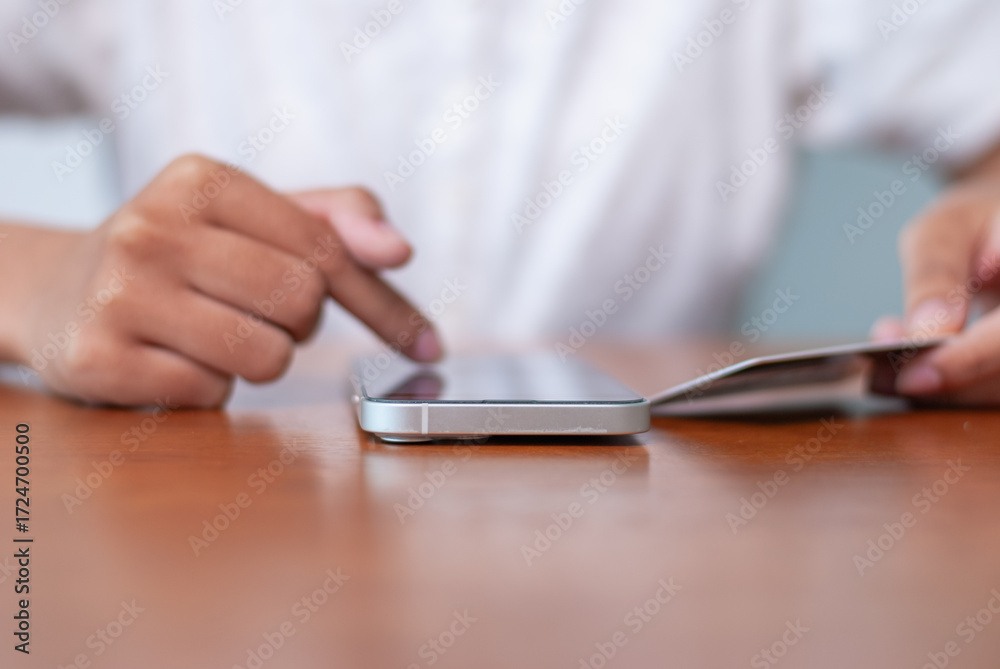 Fototapeta premium Mobile payment interaction office desk smartphone usage modern workspace close-up digital communication