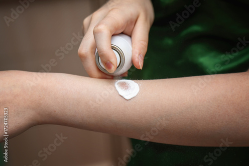 Wallpaper Mural Teenager applying first aid burn foam from a spray can onto a thermal injury on hand Torontodigital.ca